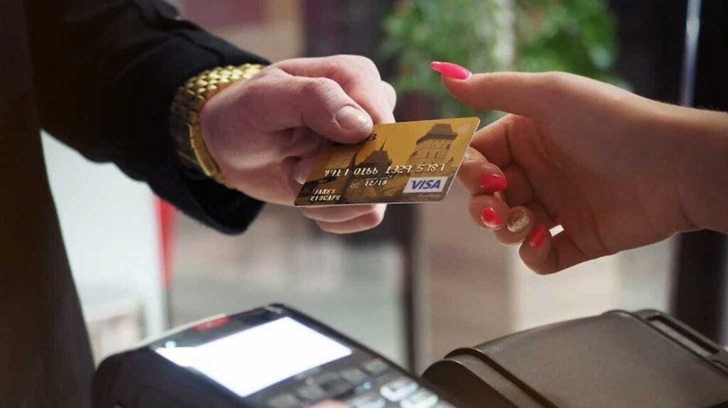 A credit card exchanging hands at a shop