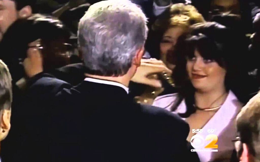 Monica Lewinsky greeting Bill Clinton in a crowd.