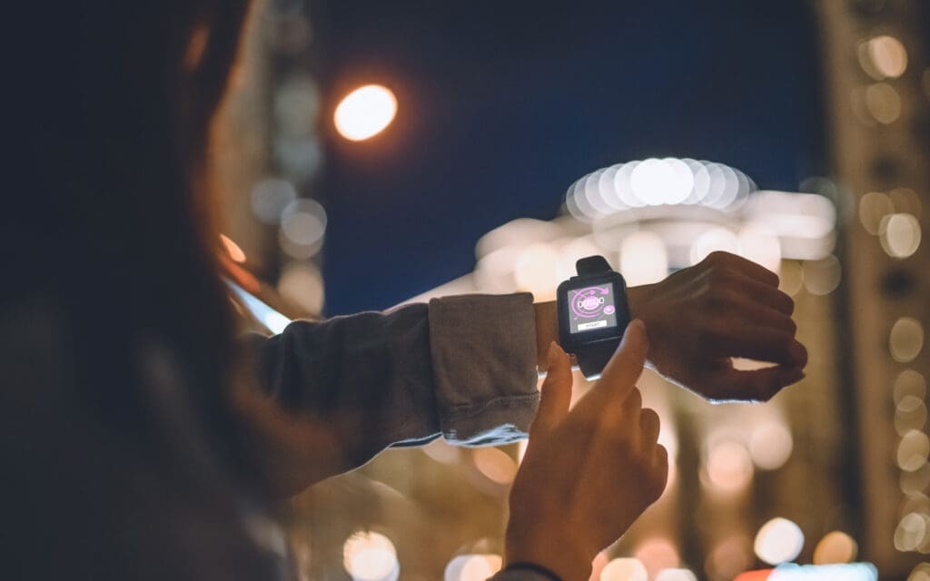 Woman checking smartphone at night