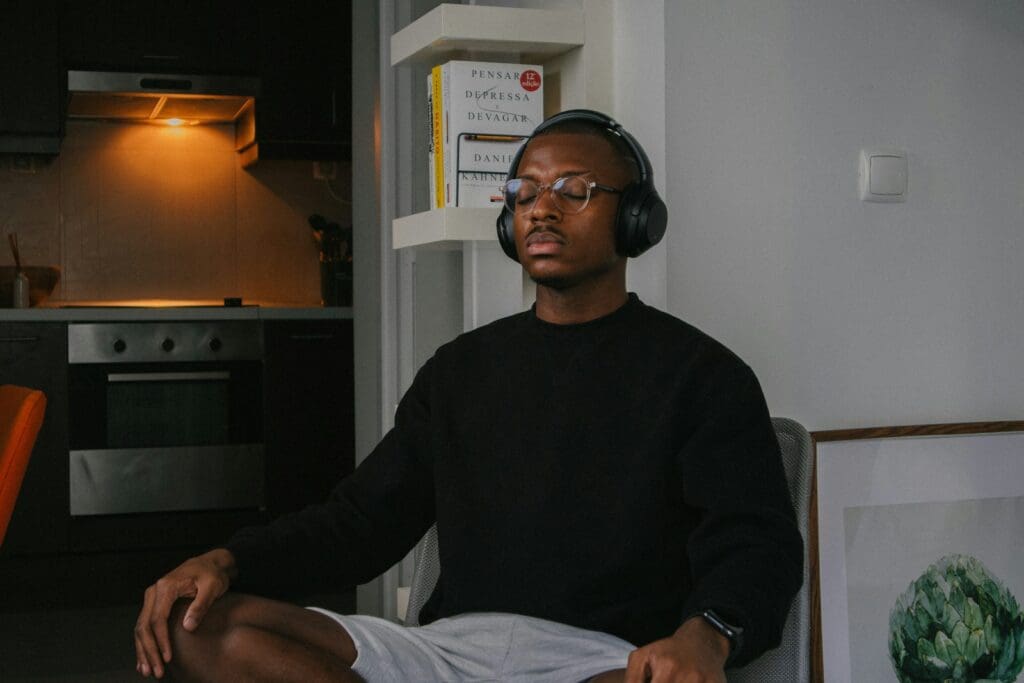 a man sitting in a chair wearing headphones