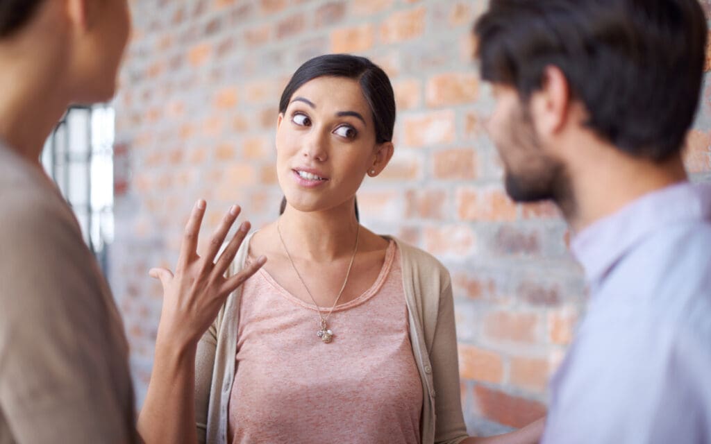 Woman explaining something to two men.