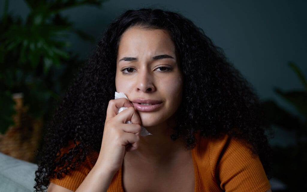 crying woman holding a tissue
