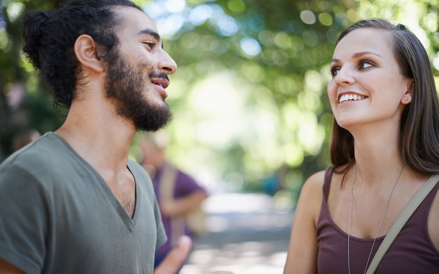 man and woman talking outdoors