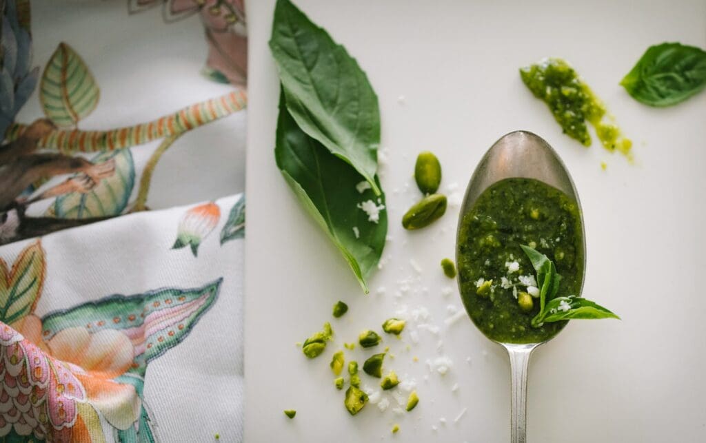 green leaves and gray spoon with pesto