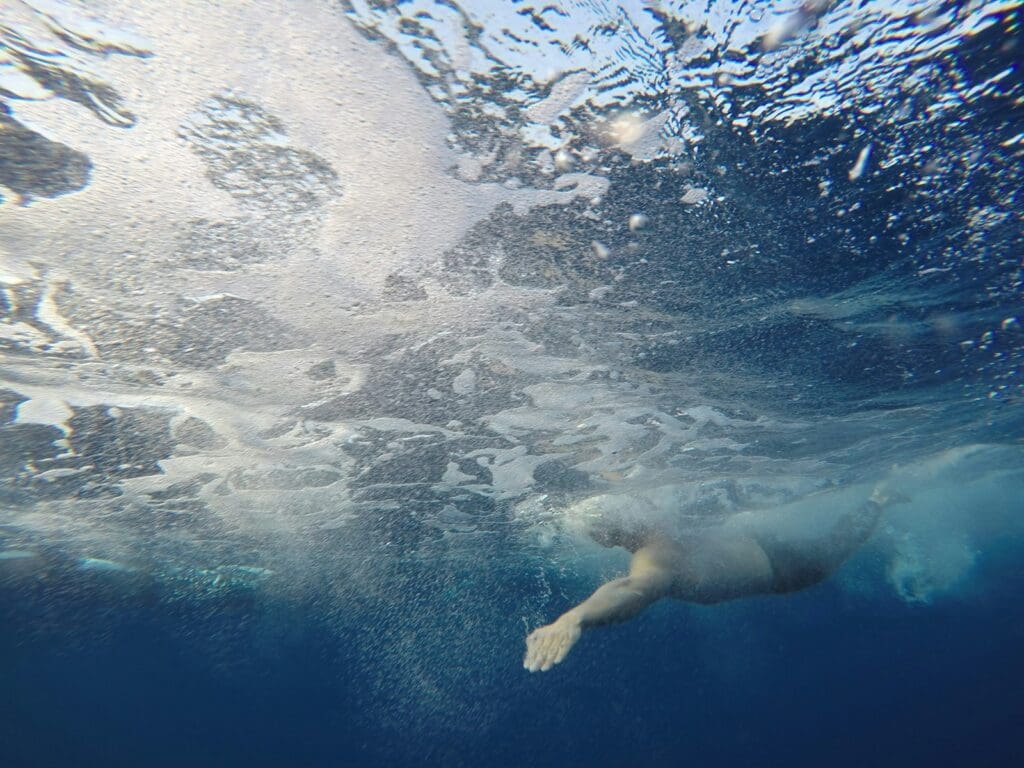 person diving under water