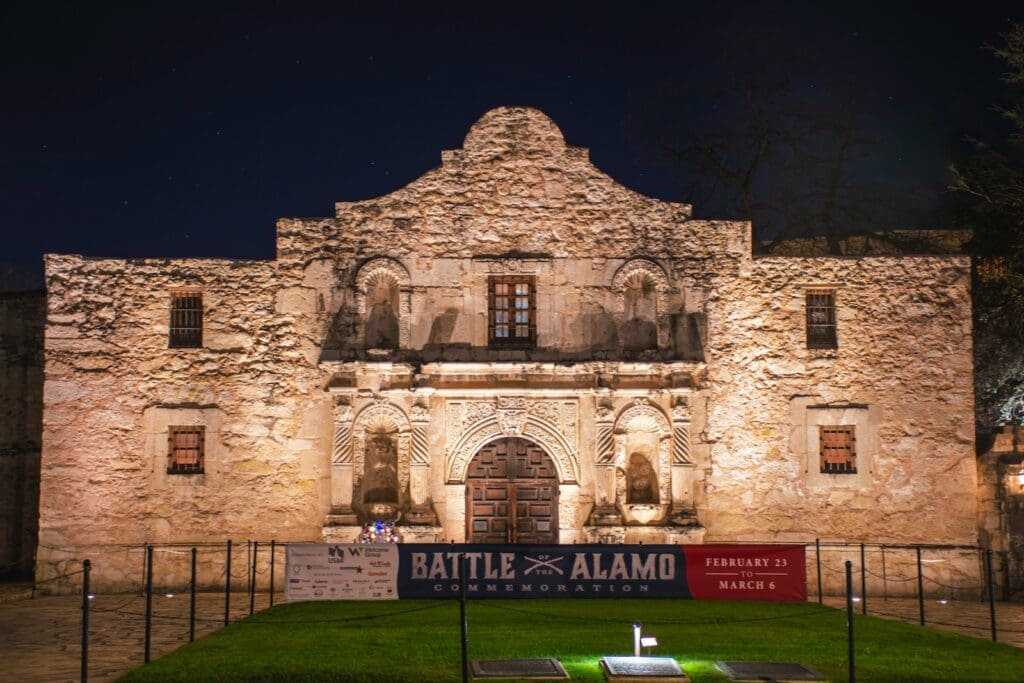 a large stone building with a sign in front of it