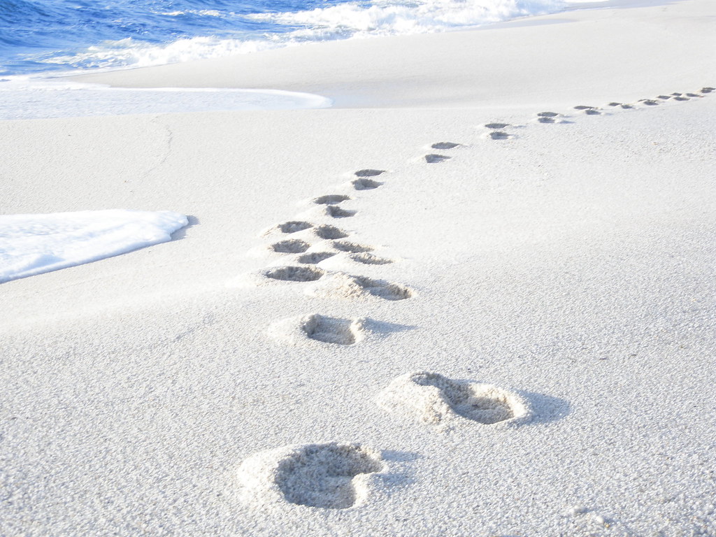 Footsteps in white sand