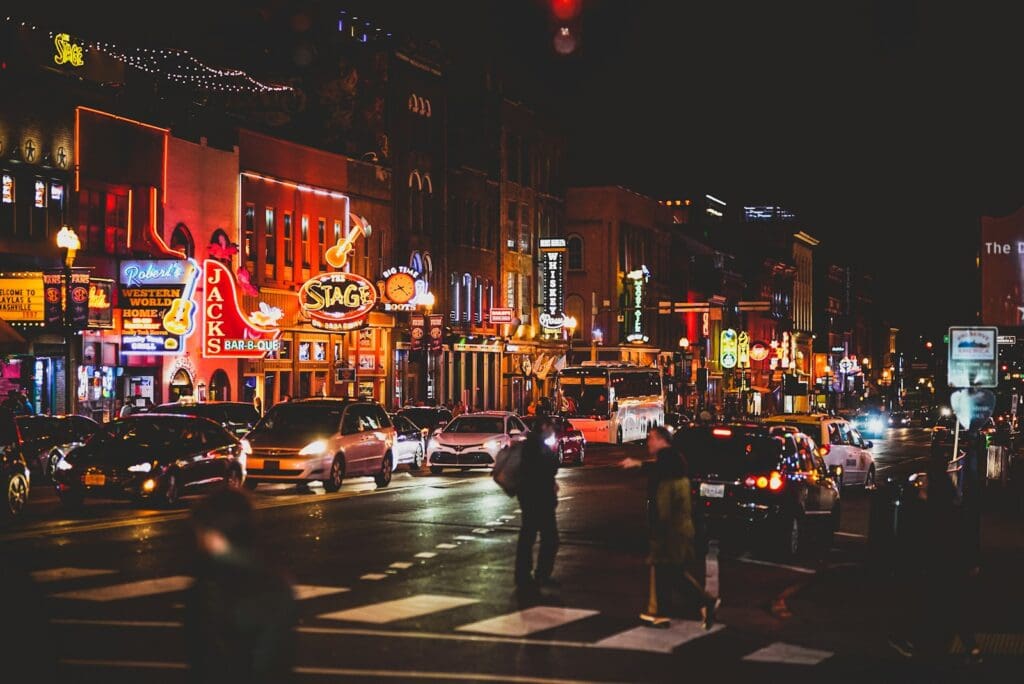 people walking on sidewalk during night time