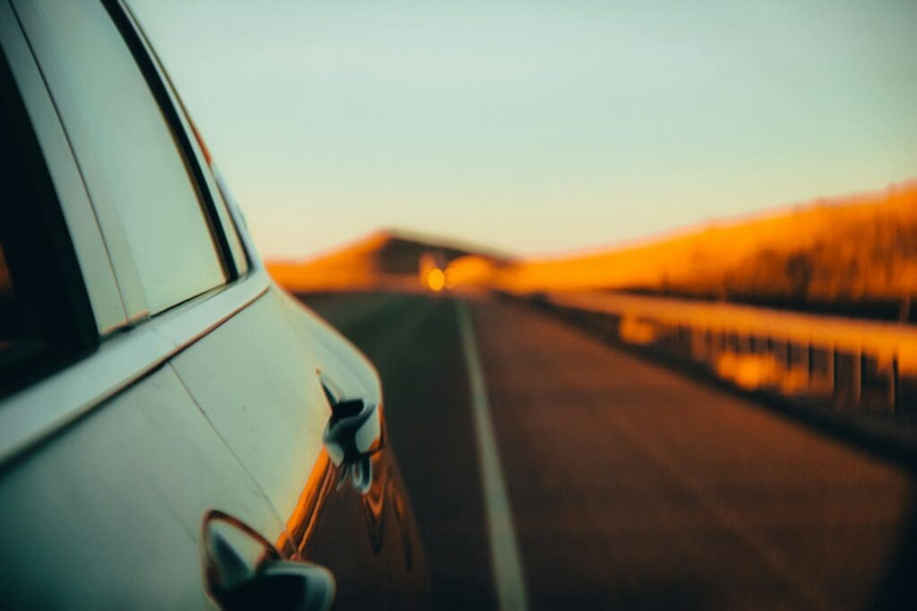 black car on road during sunset