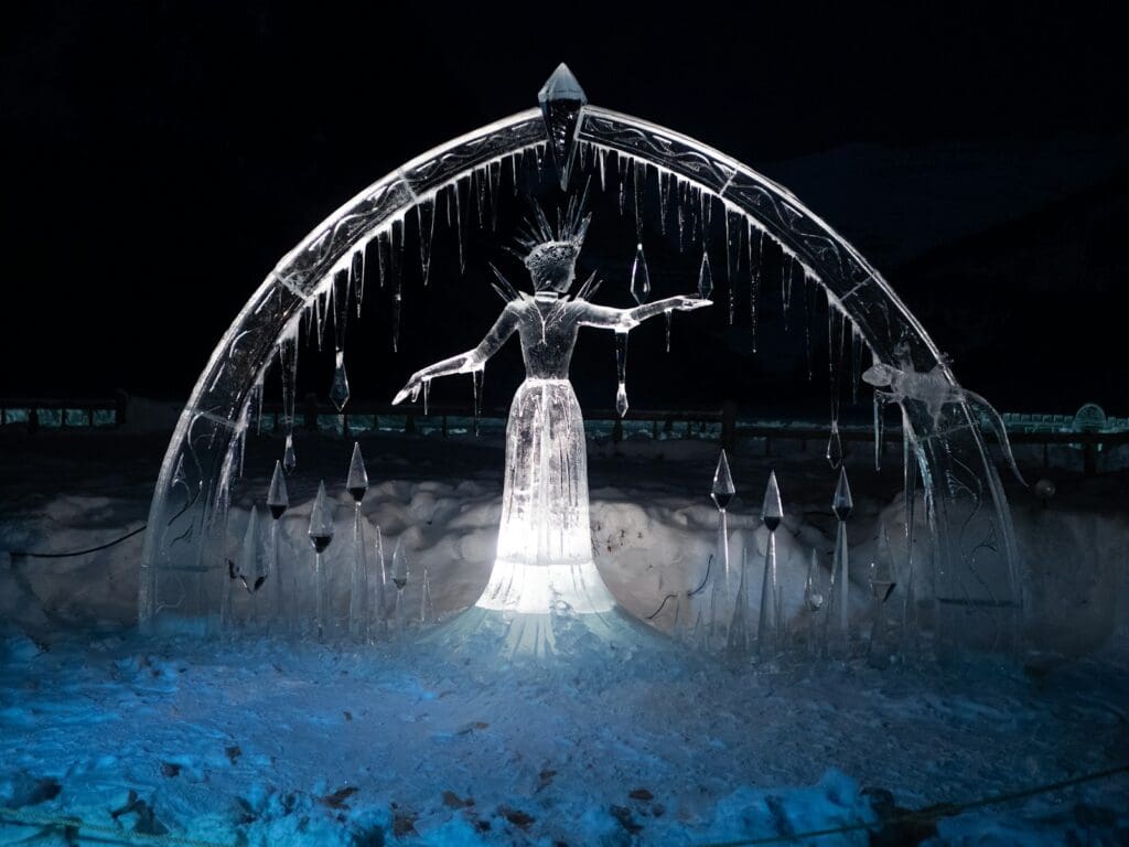 angel statue in a city with lights