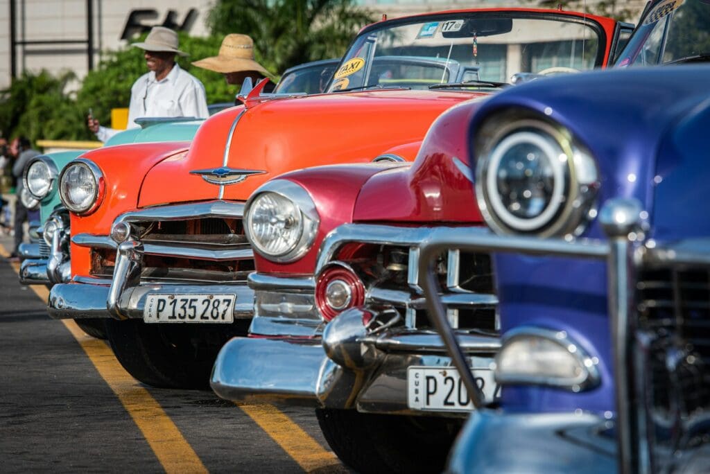 orange, red, and blue vintage cars