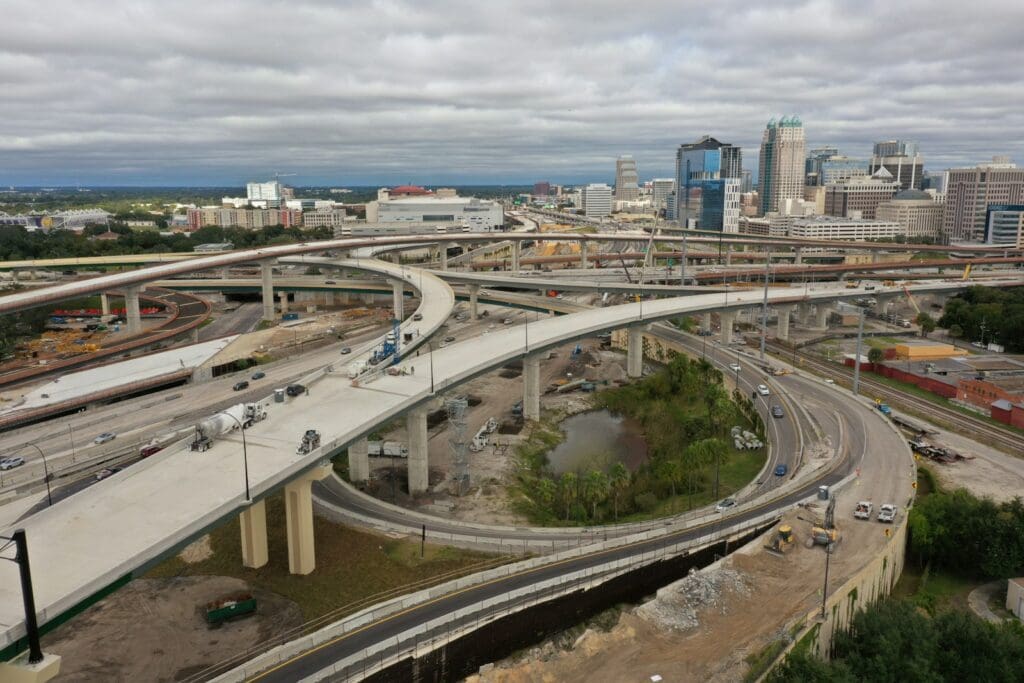 cars on road near city buildings during daytime