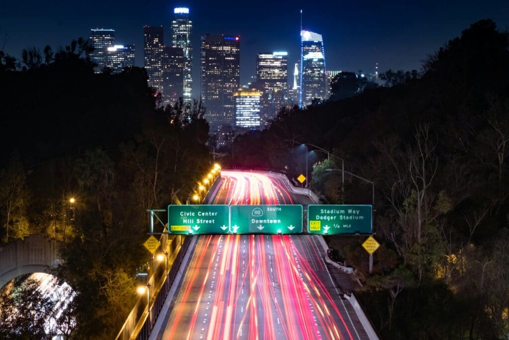 time lapse photography of highway leading to city