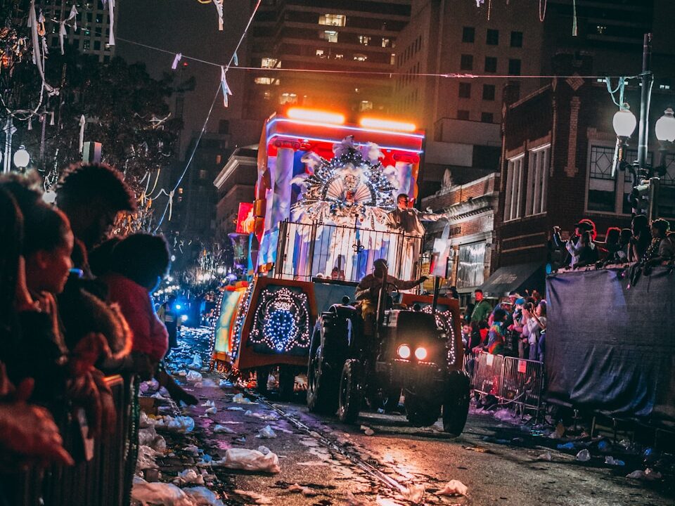 person riding on tractor surrounded by peoples