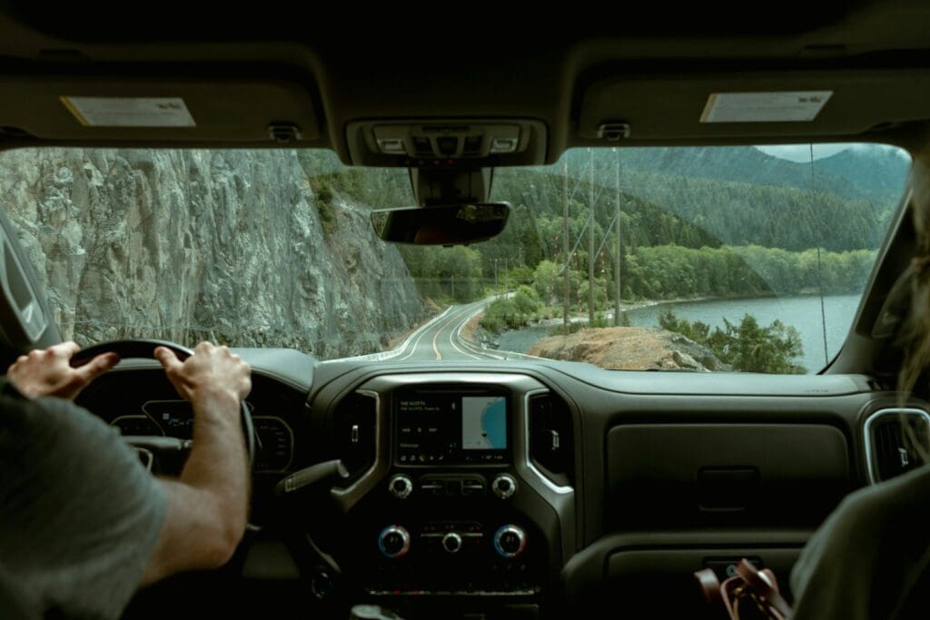 a man driving a truck down a curvy road