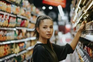 woman selecting packed food in a sstore