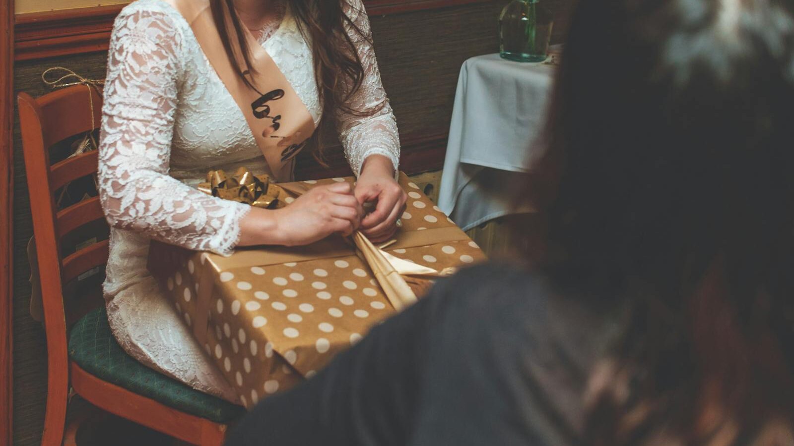 Woman Sitting on Chair Holding Gift