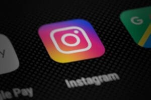 Instagram app icon on smartphone screen (perspective render)