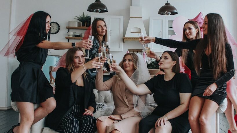 group of women sitting on white floor