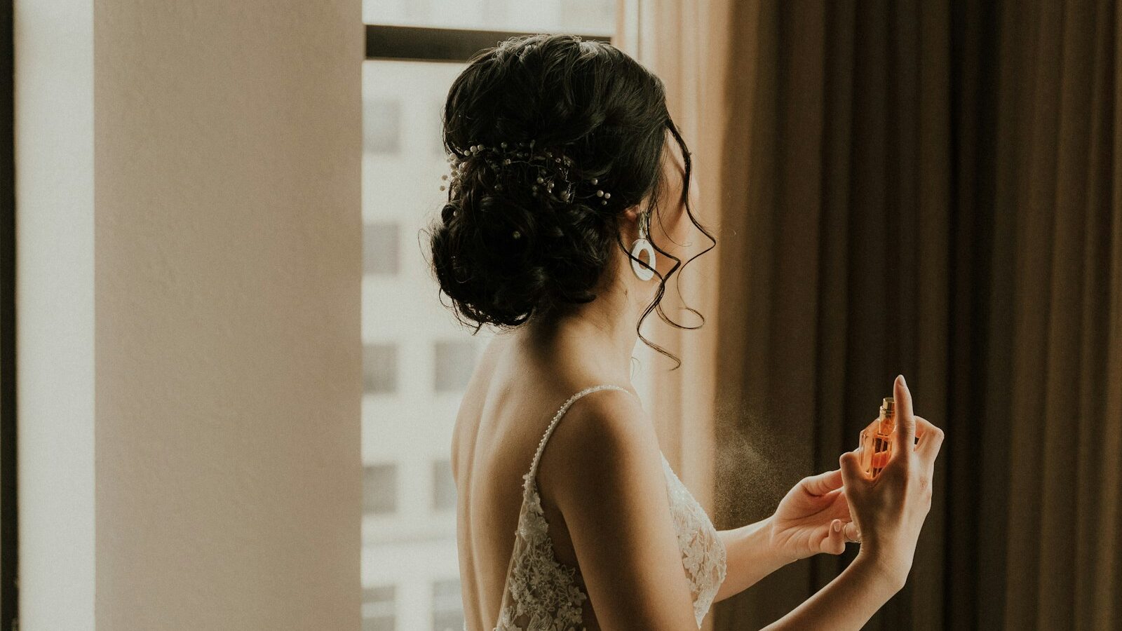 a woman standing in front of a window 