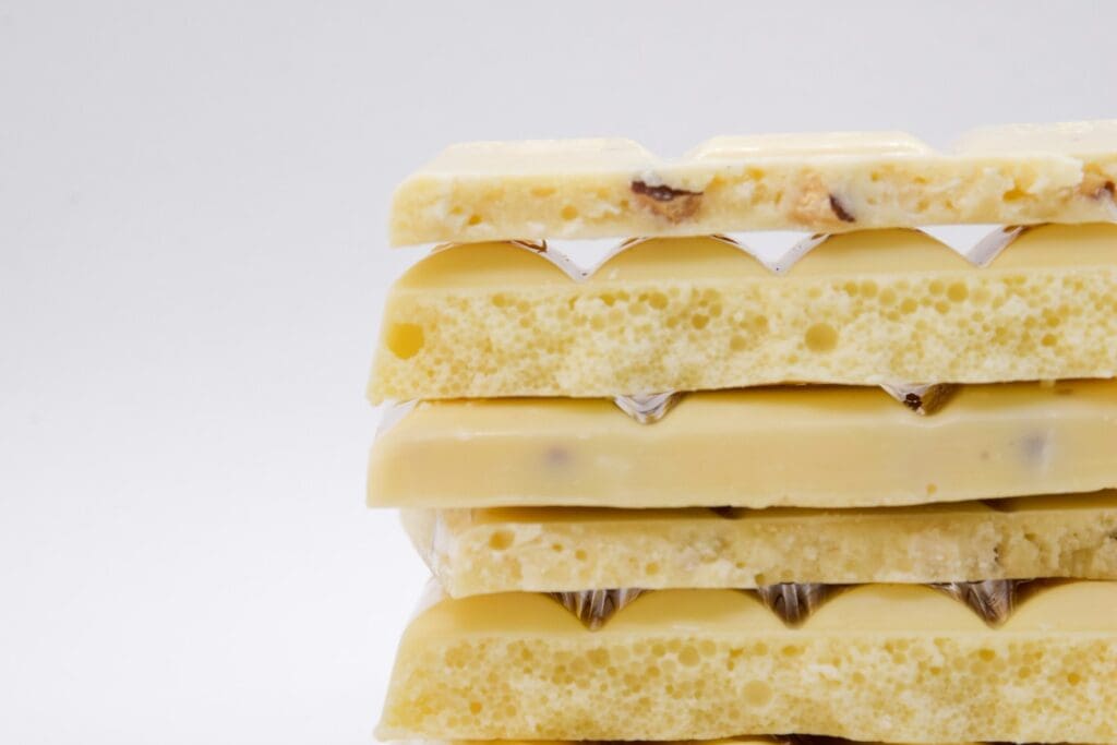 a stack of four pieces of white chocolate sitting on top of each other