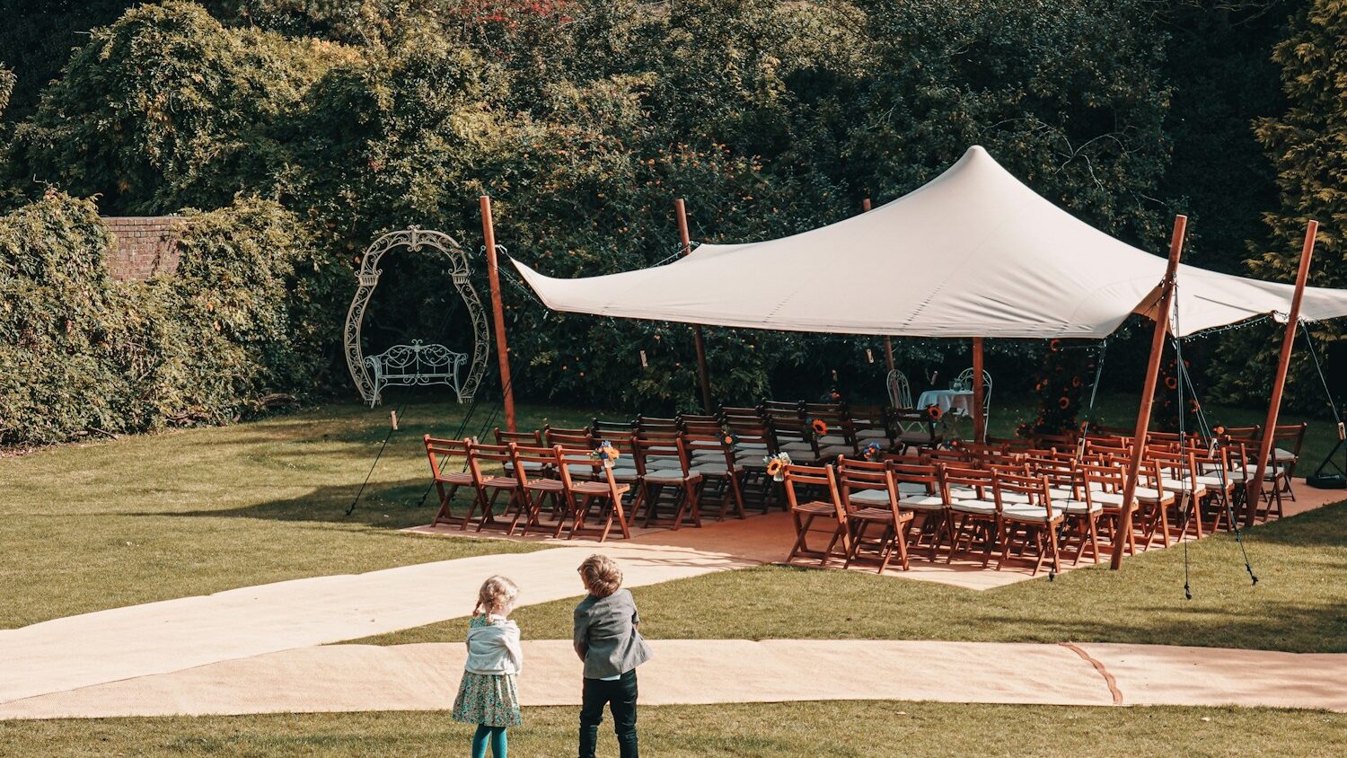 a couple of kids standing in front of a tent