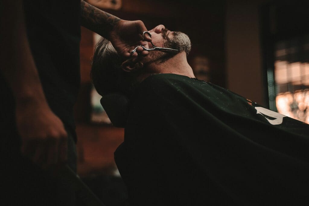 man sitting on barber's chair