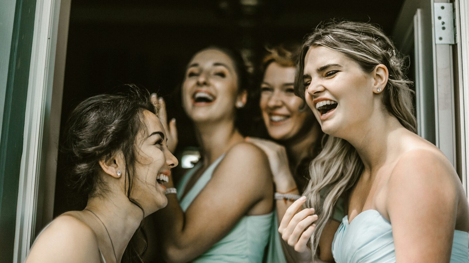 woman wearing teal tube dress while smiling