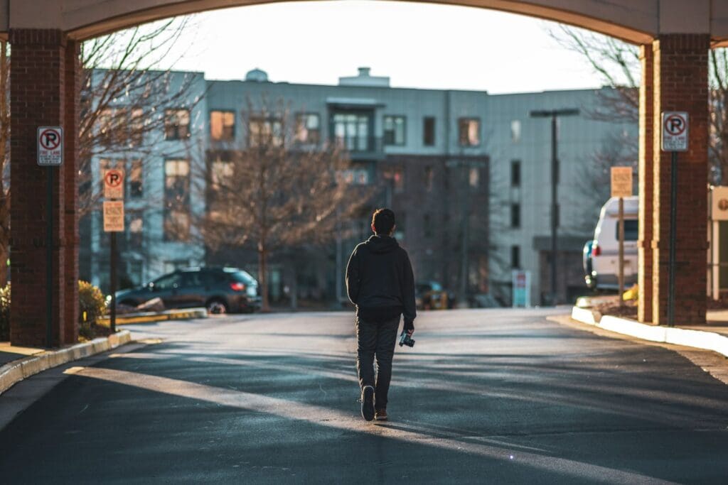 man walking on street near buildings