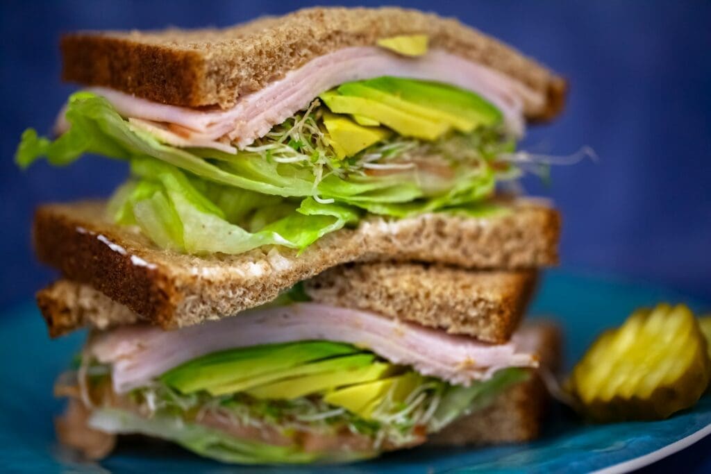 sandwich with ham and green vegetables