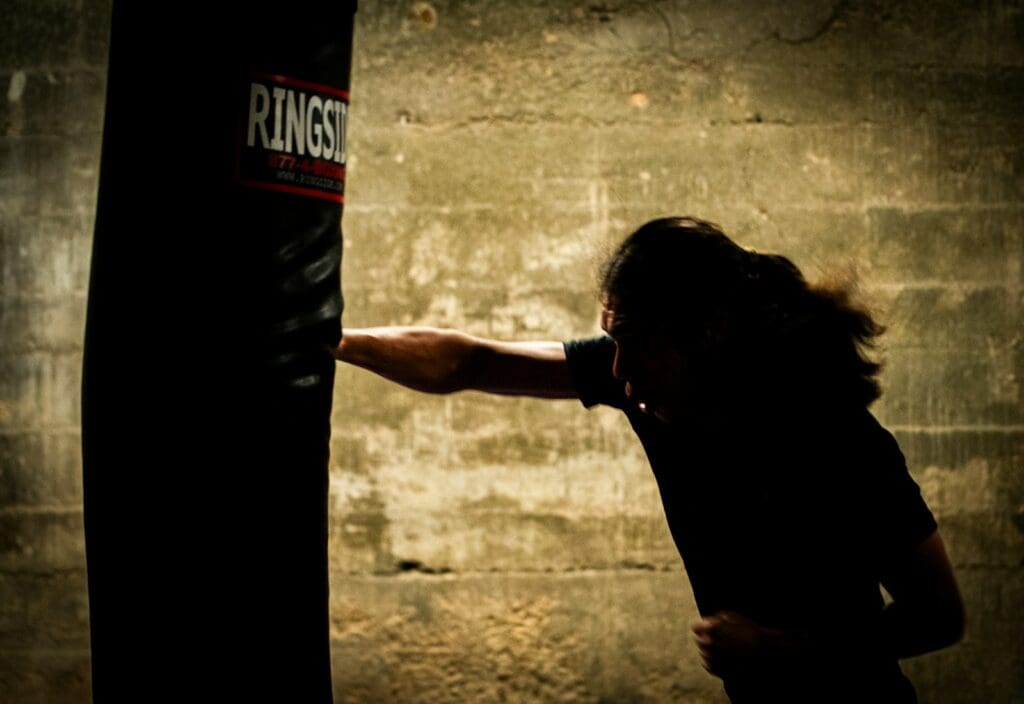 An athlete striking a punching bag