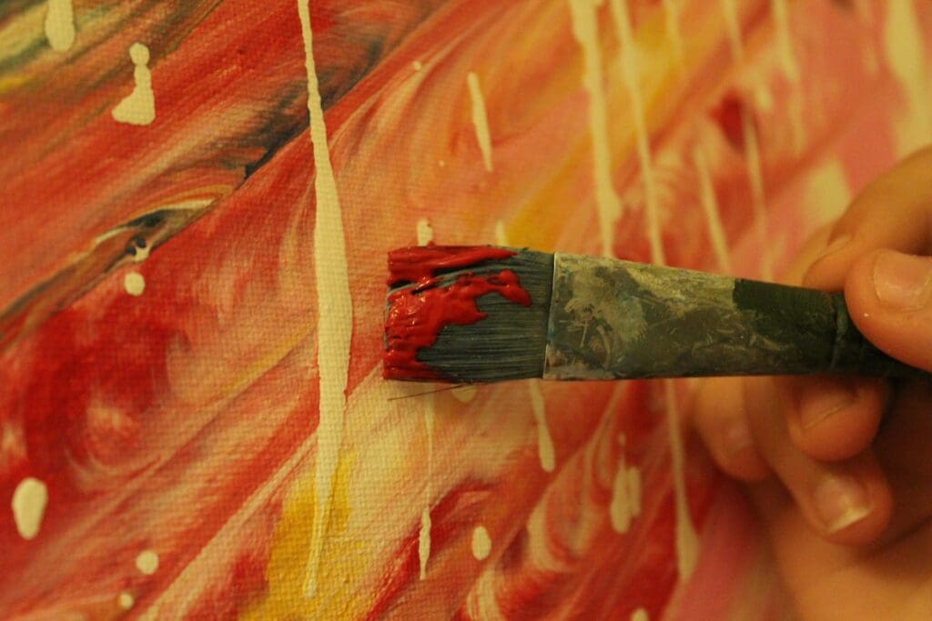 a person holding a paintbrush in their hand