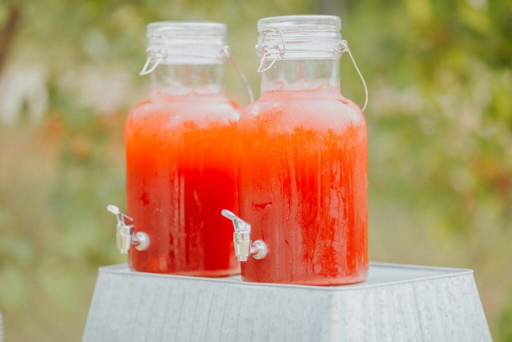 a couple of plastic bottles with red liquid in them