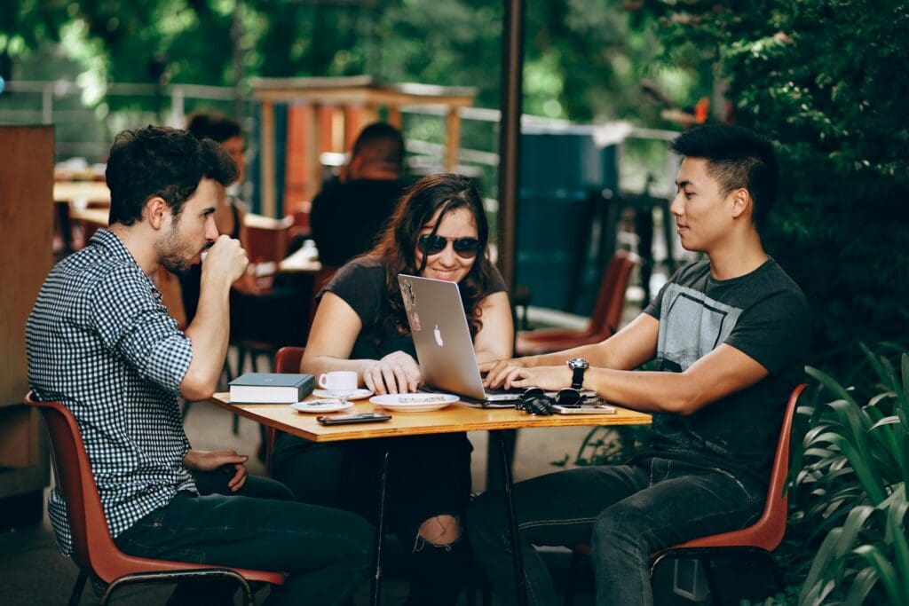 photo of three people sitting and talking