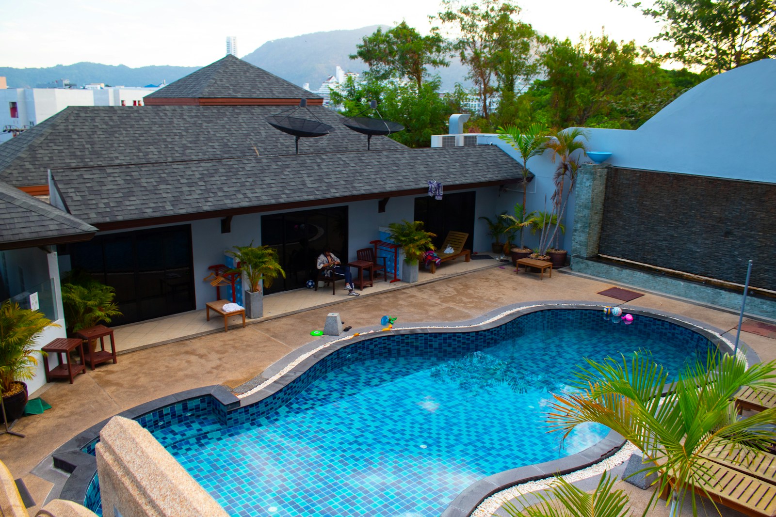 swimming pool near green trees during daytime