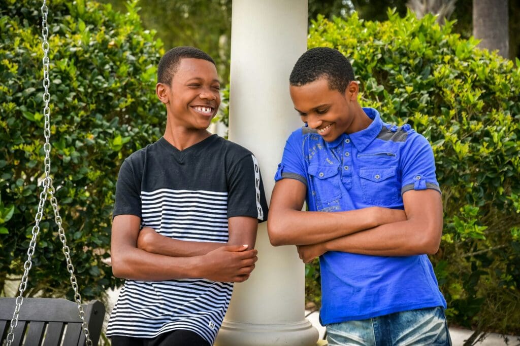 man in blue button up shirt beside man in black and white stripe shirt