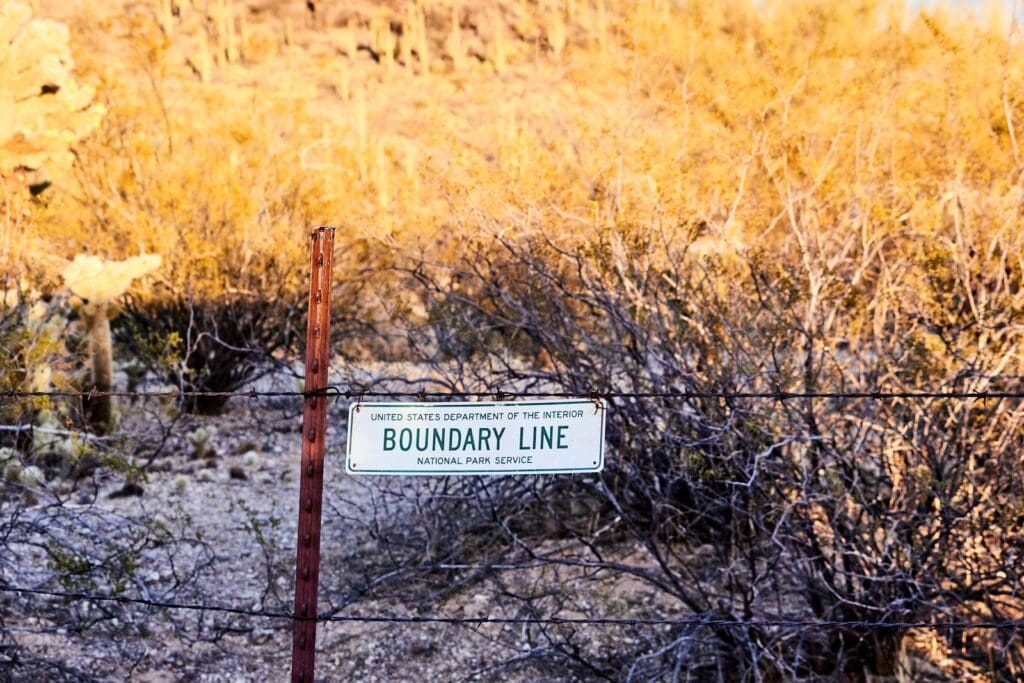 white and black boundary line sign