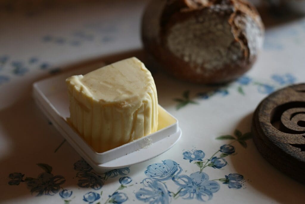 A piece of butter sitting on top of a white plate