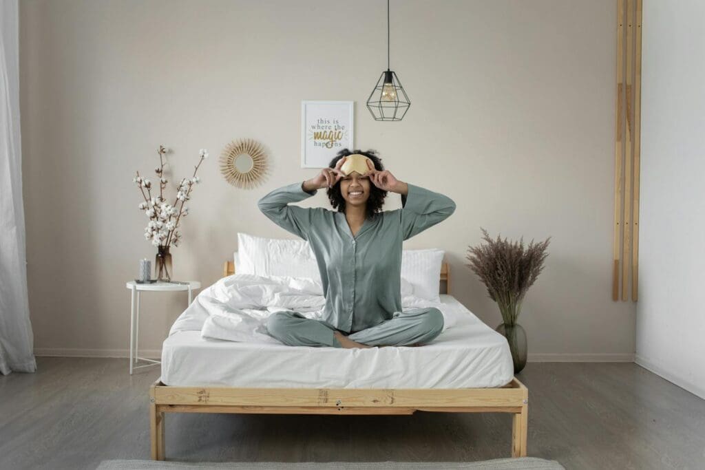 Woman in Pajamas Sitting on Bed