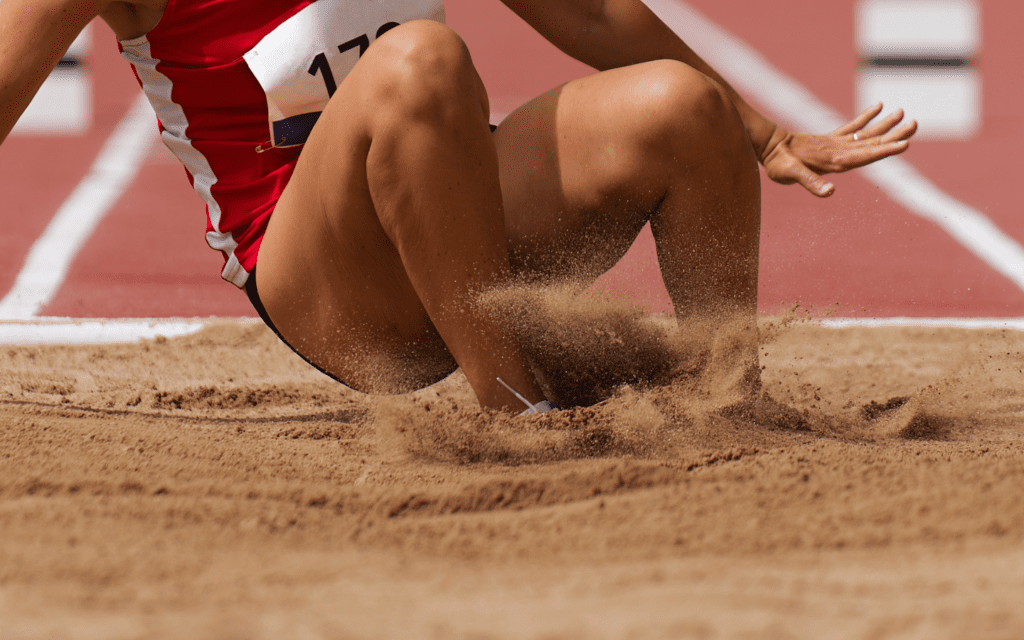 Adobe Stock, long jump into sand