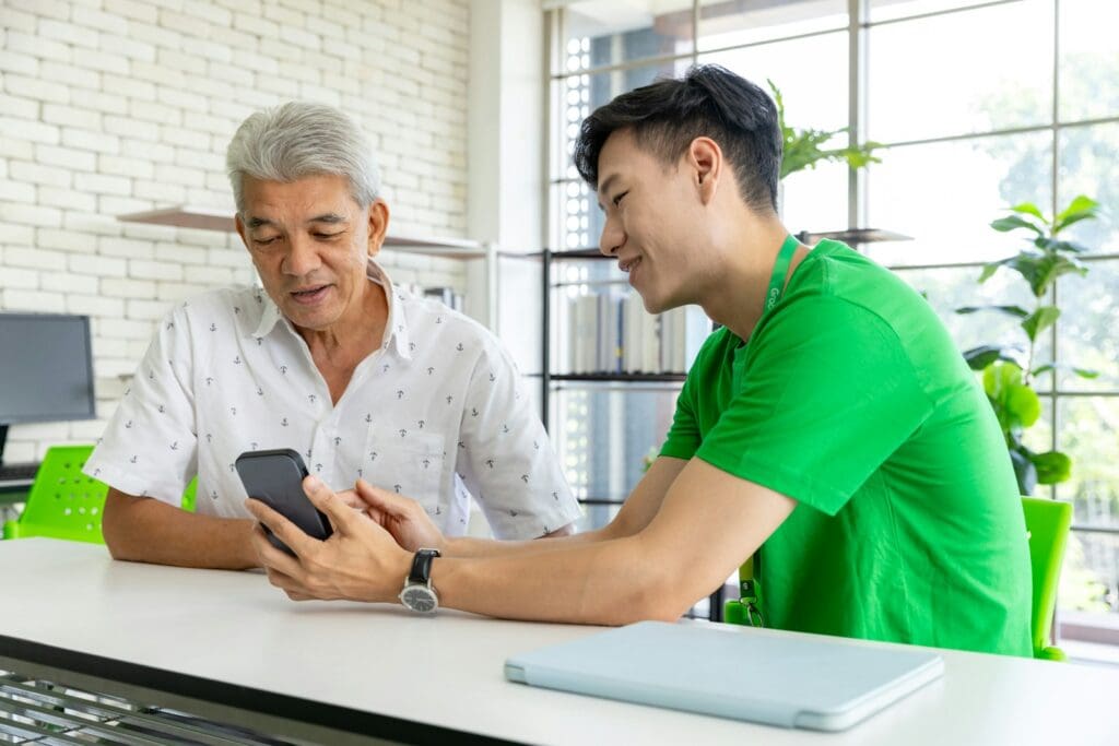 a man and a woman looking at a cell phone