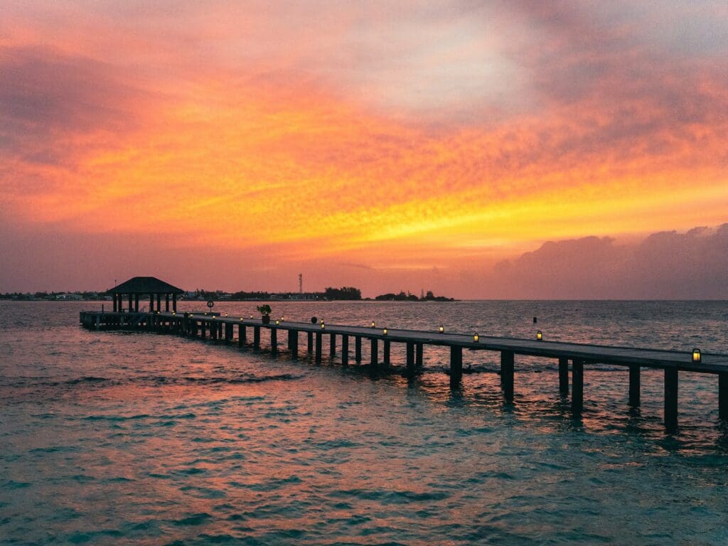 a long pier with a gazebo in the distance