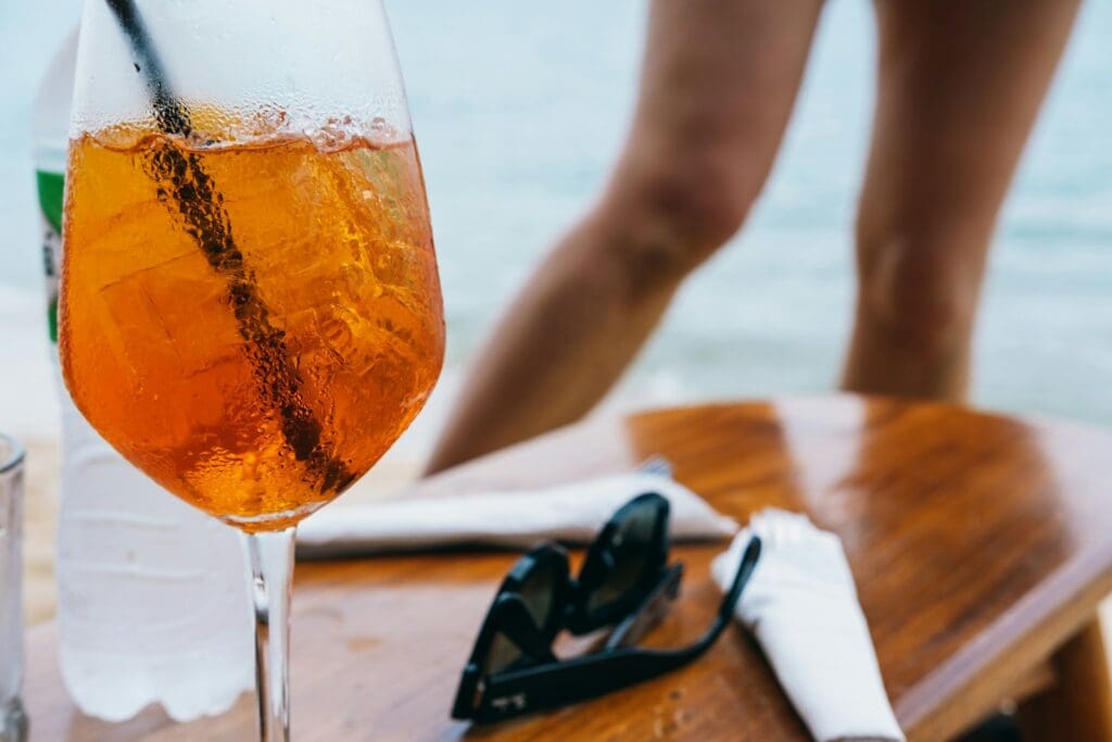 a glass of wine sitting on top of a wooden table