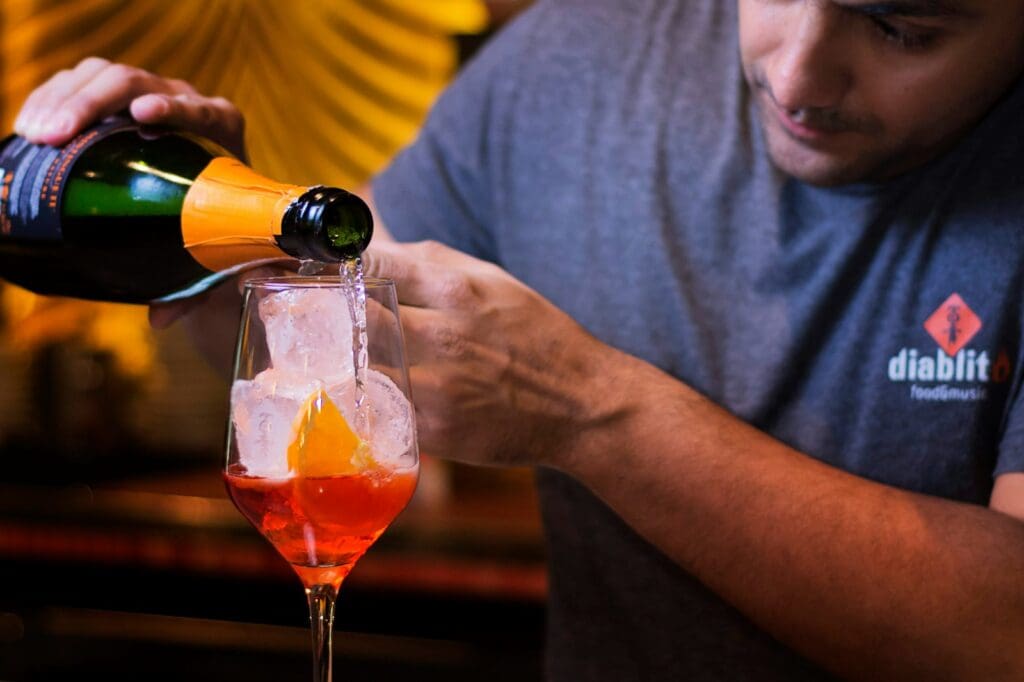 man in gray crew neck t-shirt holding clear wine glass