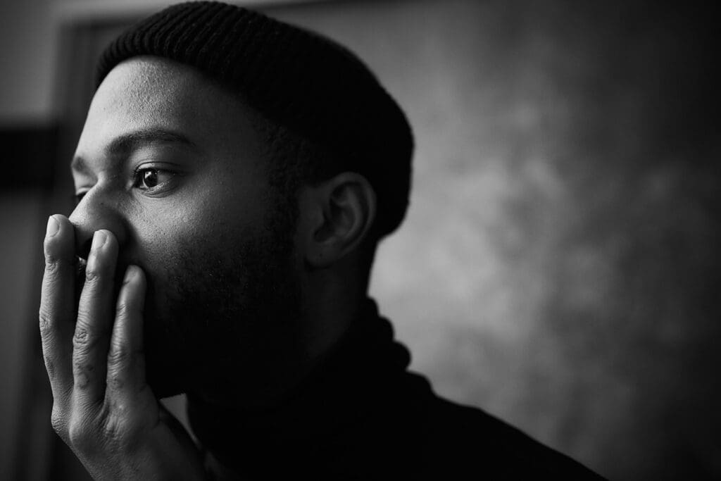 man in knit cap grayscale photo