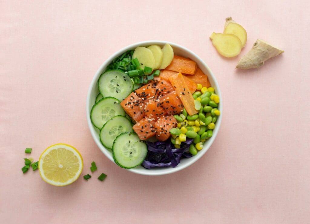 sliced cucumber and sliced lemon on white ceramic bowl