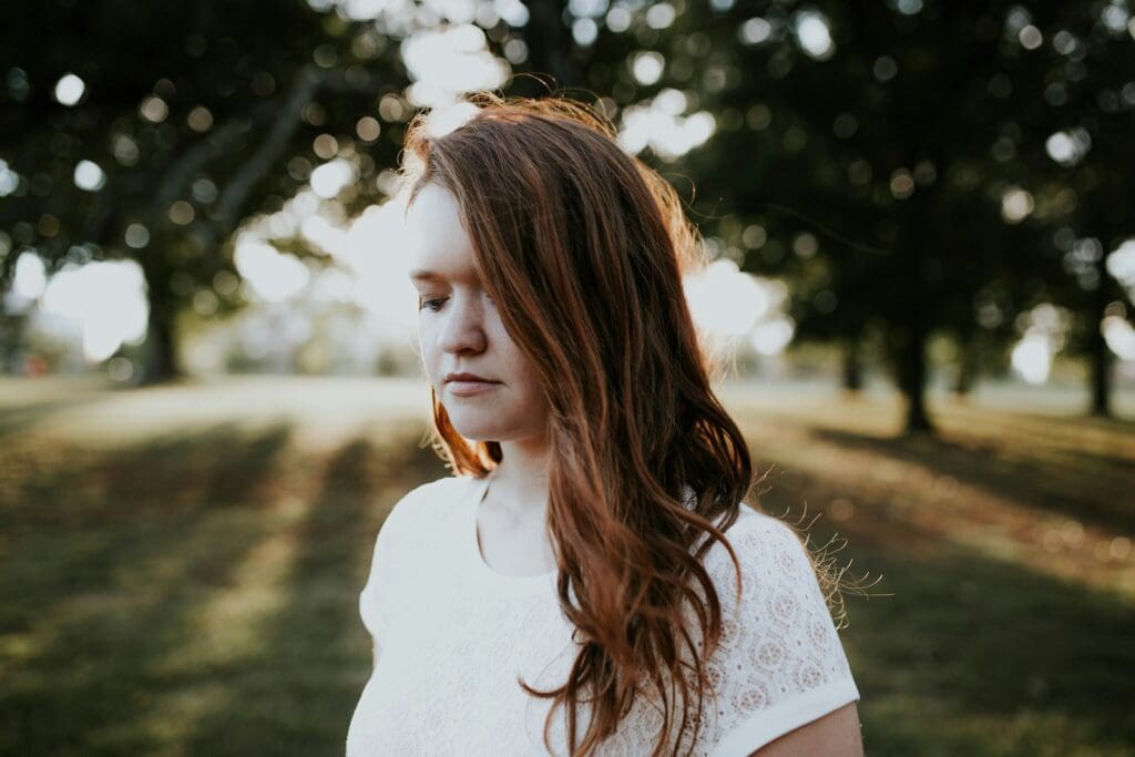 woman standing near trees during daytime