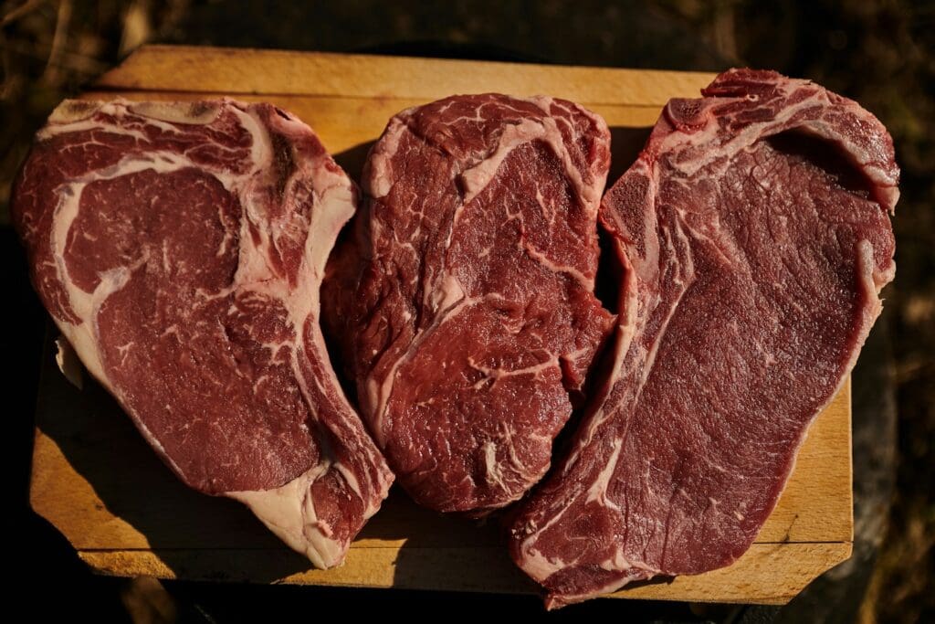 two pieces of steak on a cutting board