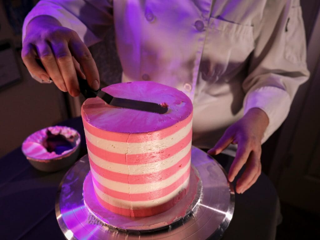 a person cutting a cake with a knife