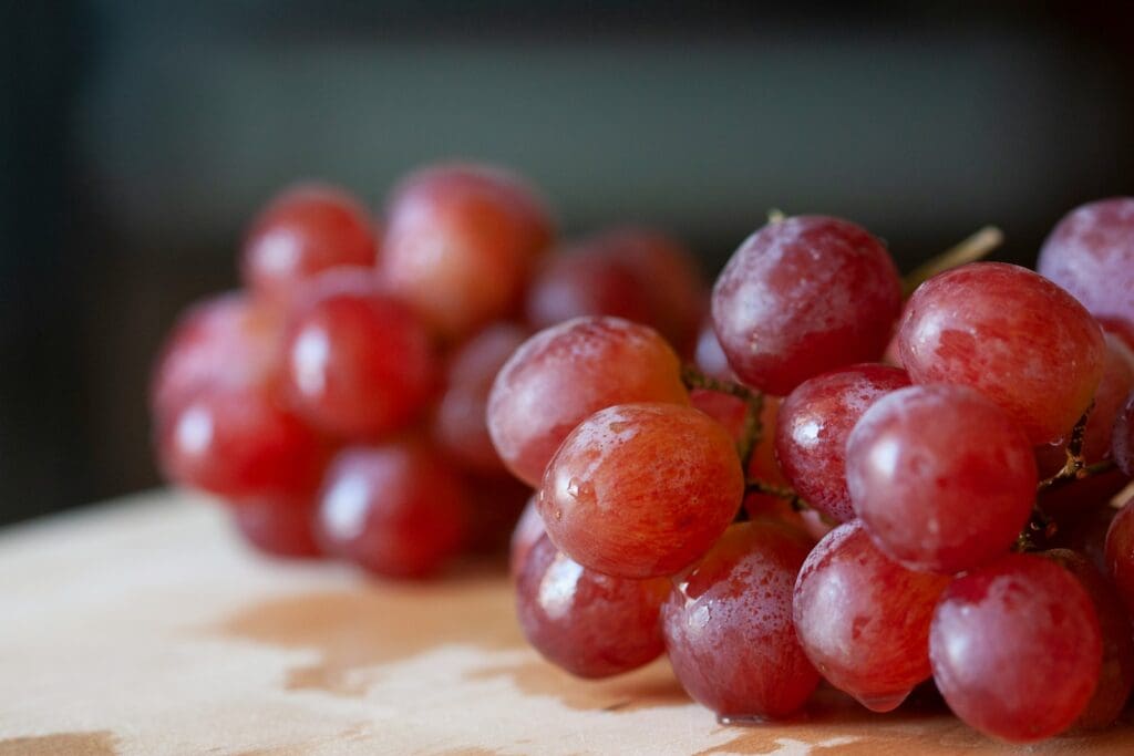 red round fruits on brown wooden table